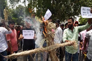 Students burn an effigy during their protest against the NEET UG entrance exam paper leak, in Patna