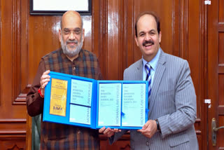 Amit Shah releasing reference books on new criminal laws on Dec 30, 2023. (Right) Dr Vinay Ahuja, Managing Director of Mohan Law House.
