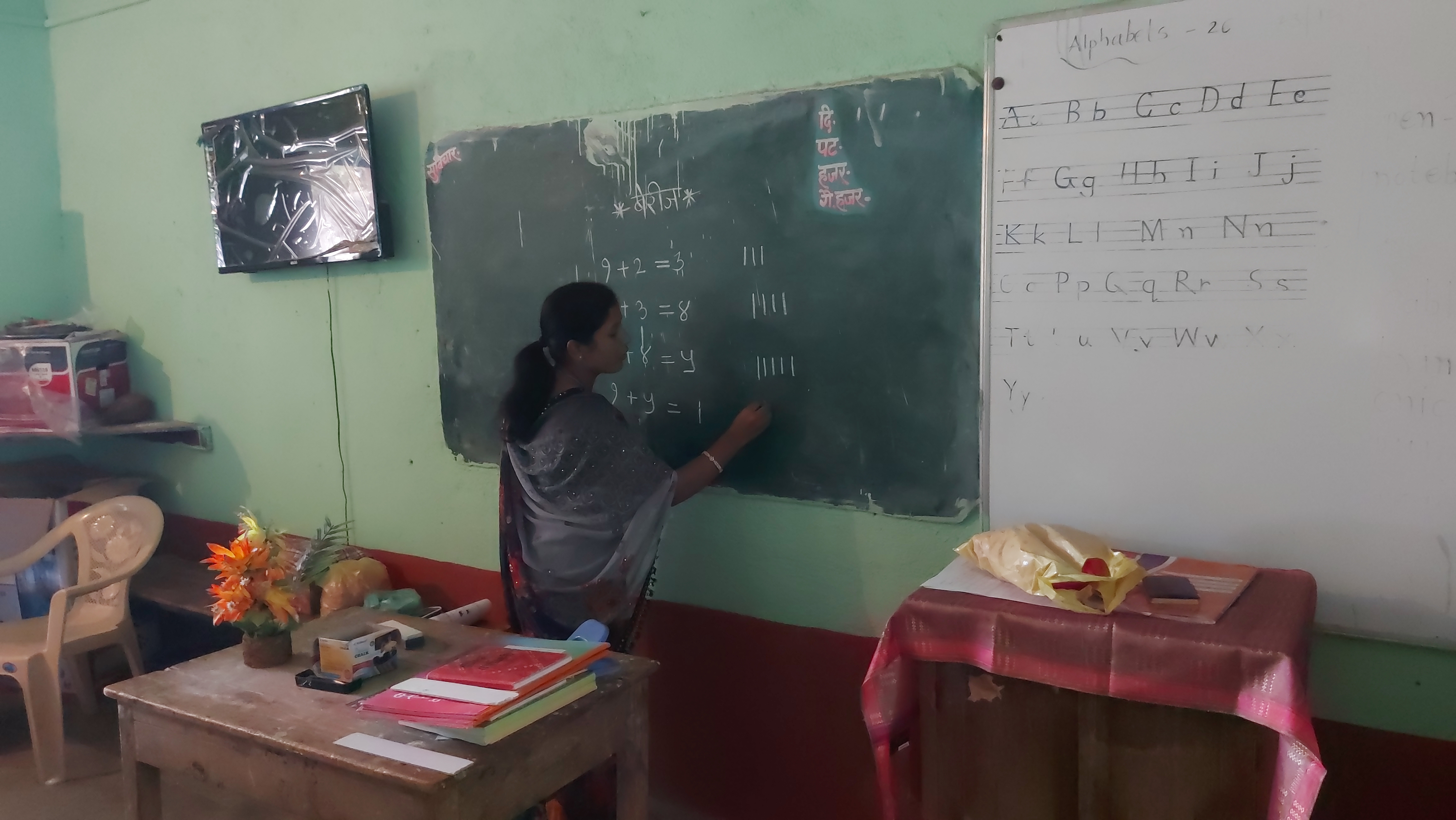 Woman Sarpanch teaching students