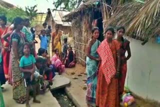 People gathered in front of the hut