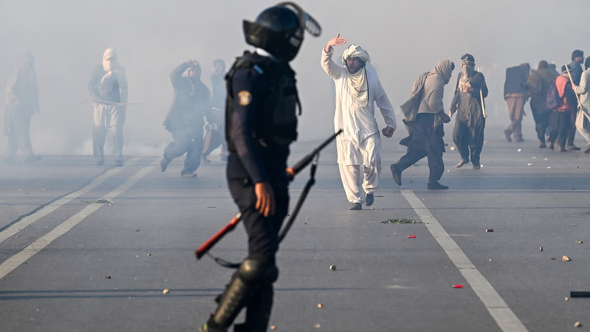 Policemen fire tear gas shells to disperse supporters of Pakistan Tehreek-e-Insaf (PTI) party during a protest to demand the release of former prime minister Imran Khan, in Islamabad on November 26, 2024.