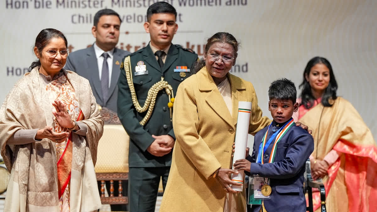 President Droupadi Murmu confers the Pradhan Mantri Rashtriya Bal Puraskar to an awardee, at the Rashtrapati Bhavan Cultural Centre, in New Delhi, Thursday, Dec. 26, 2024.