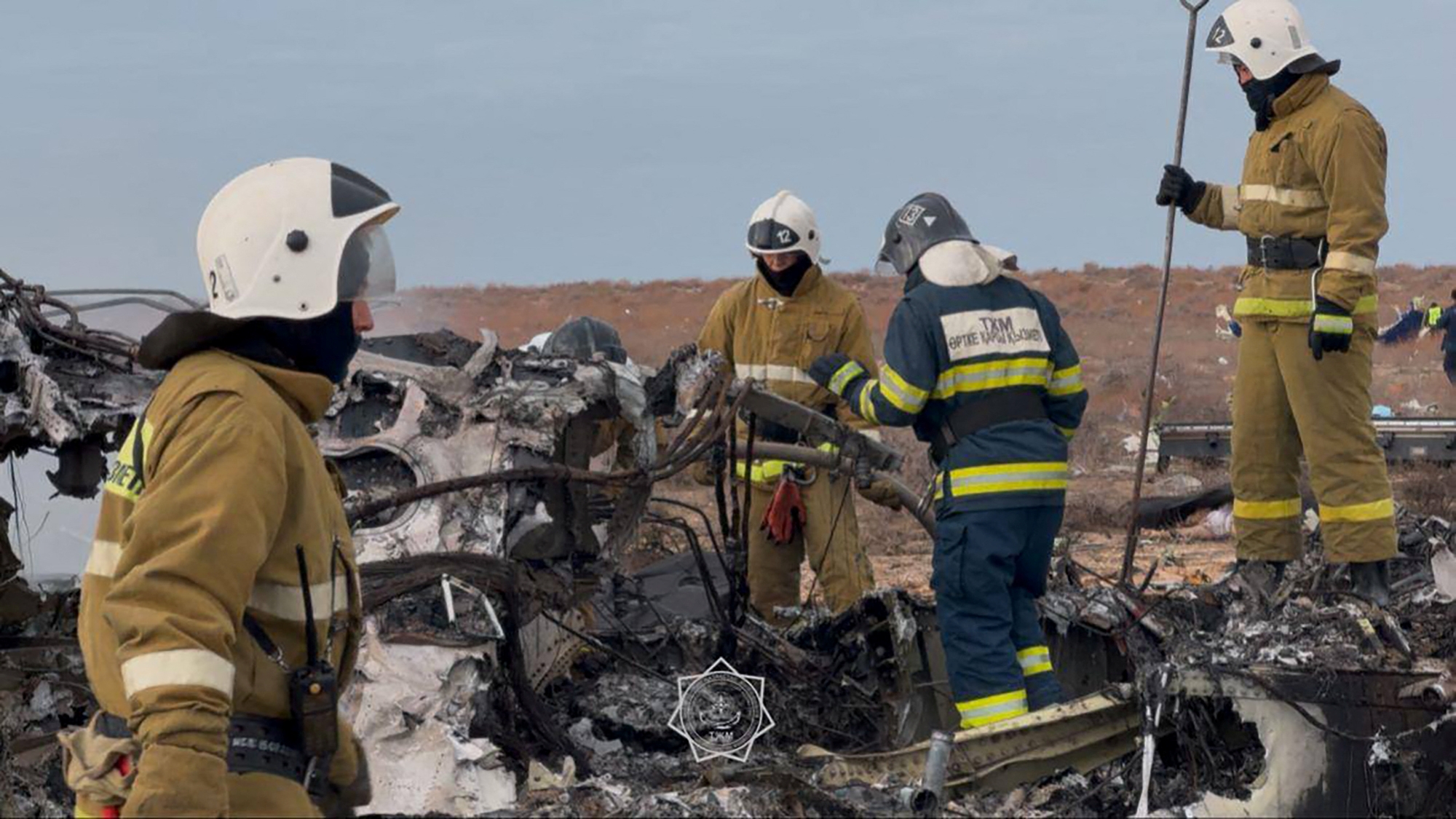 Emergency specialists work at the crash site of an Azerbaijan Airlines passenger jet near the western Kazakh city of Aktau on December 25, 2024.