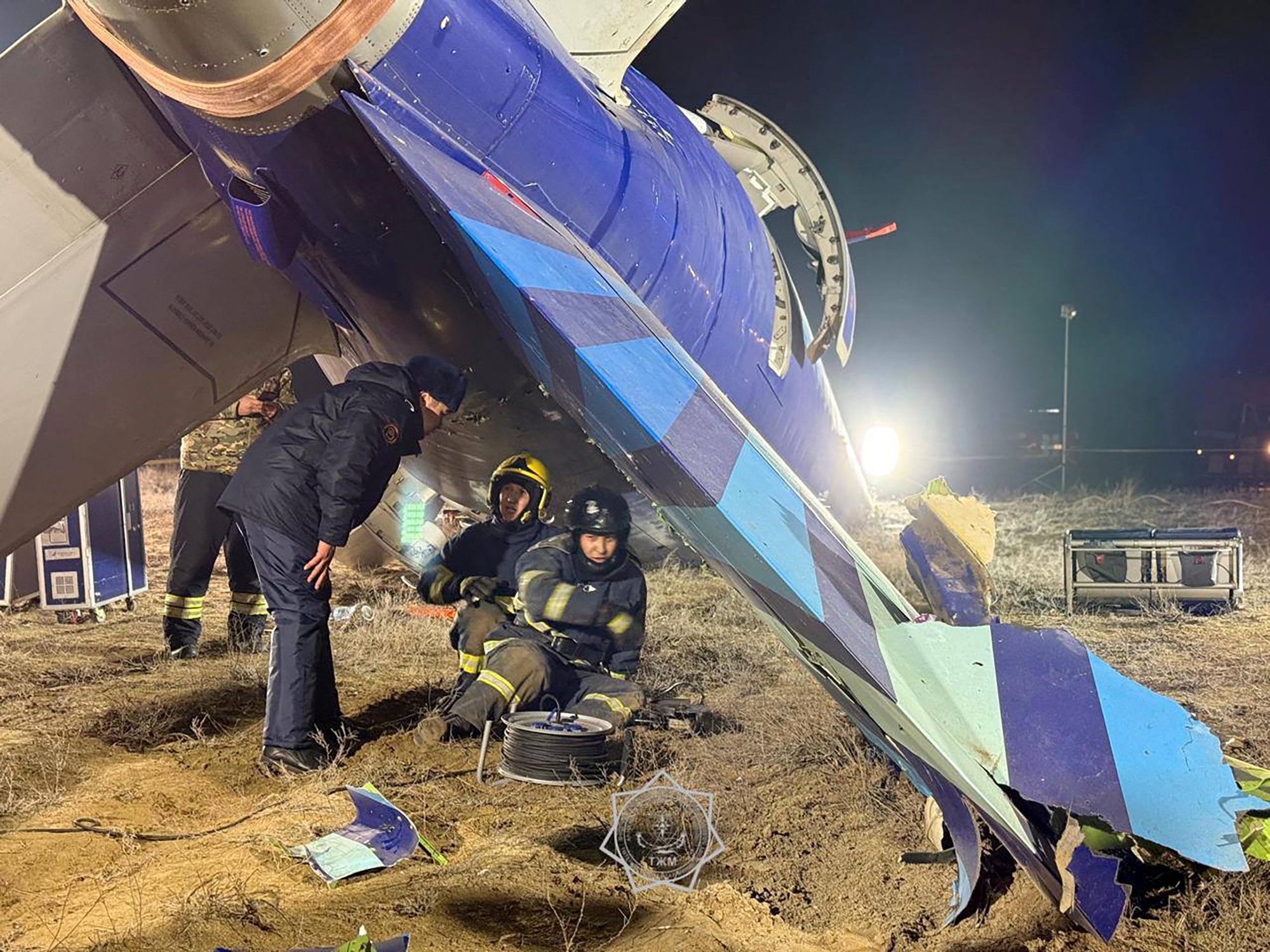 In this handout picture released by Kazakhstan's emergency situations ministry on December 26, 2024, emergency specialists work at the crash site of an Azerbaijan Airlines passenger jet near the western Kazakh city of Aktau.