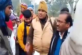 BJP MLA Prempal Dhangar (R) faces people's ire during his constituency in Firozabad