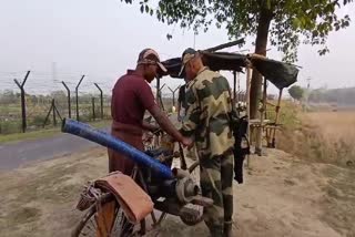 A villager helps a BSF jawan with logistics.