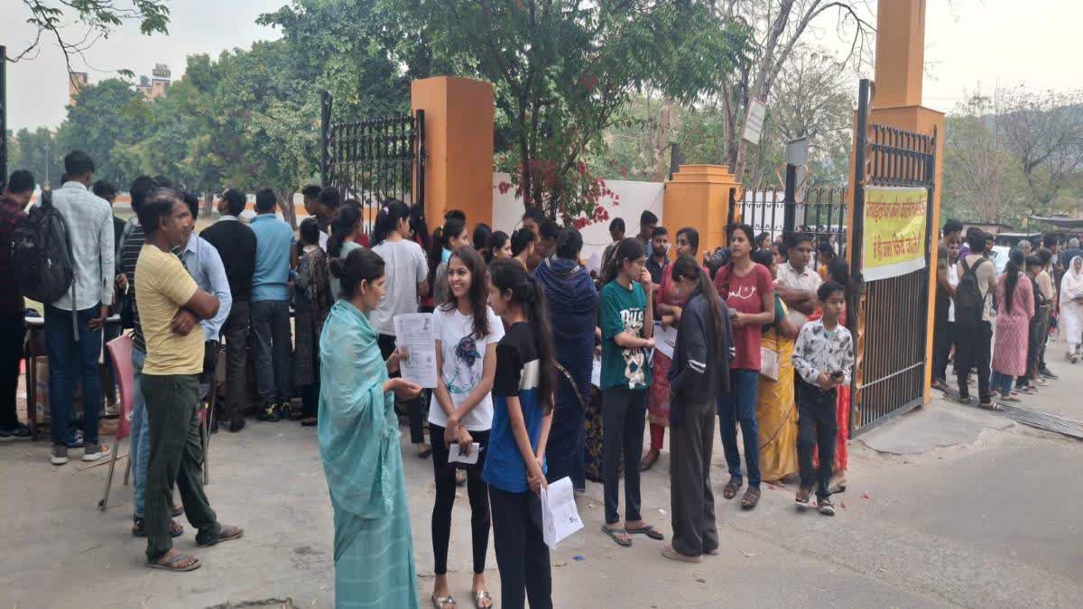 Examinees wait outside a centre for entry.