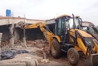 UIT bulldozer demolish illegal construction