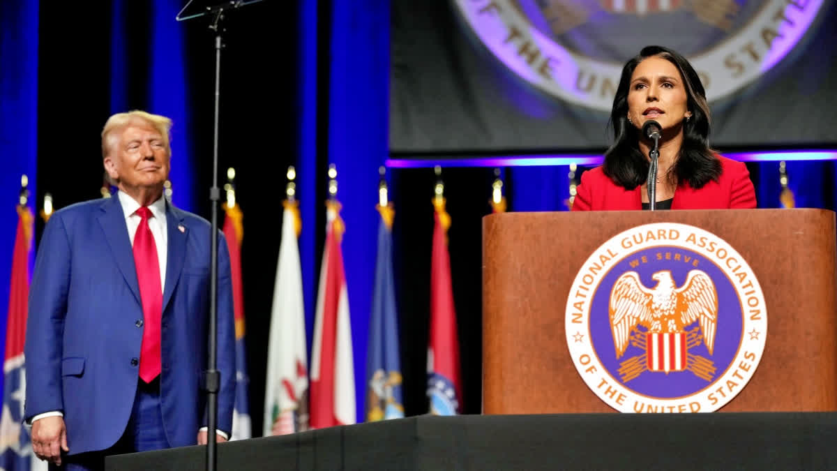 Republican presidential nominee former President Donald Trump, left, looks on as former Rep. Tulsi Gabbard of Hawaii, speaks at the National Guard Association of the United States' 146th General Conference, Monday, Aug. 26, 2024, in Detroit.