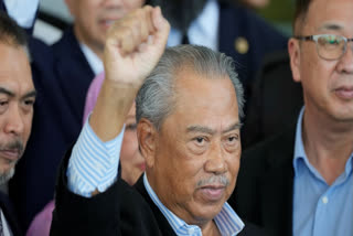 Malaysia's former Prime Minister Muhyiddin Yassin poses for media outside courthouse, after charged with corruption and money laundering, in Kuala Lumpur, Malaysia, on March 10, 2023.