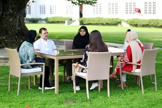 Rahul Gandhi (C) interacts with a group of young women during his recent Kashmir visit