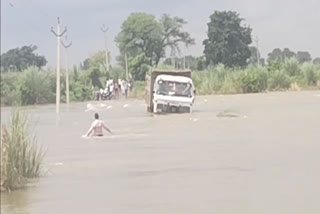 Truck stuck in flowing water