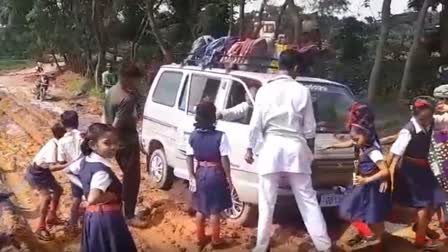 school van stuck in mud