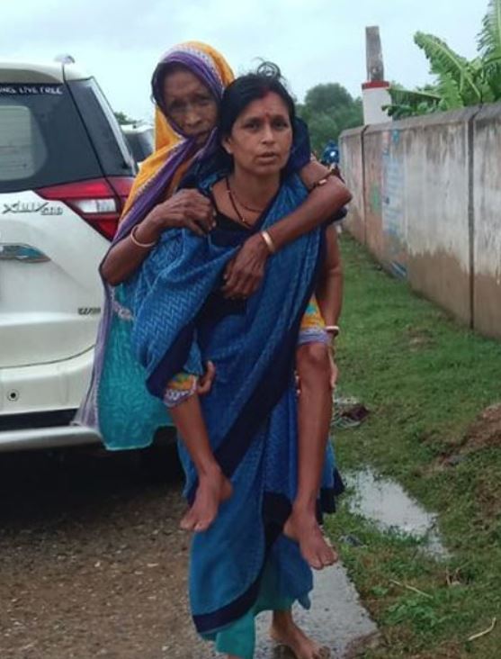 ASHA WORKER CARRIES ELDERLY WOMEN