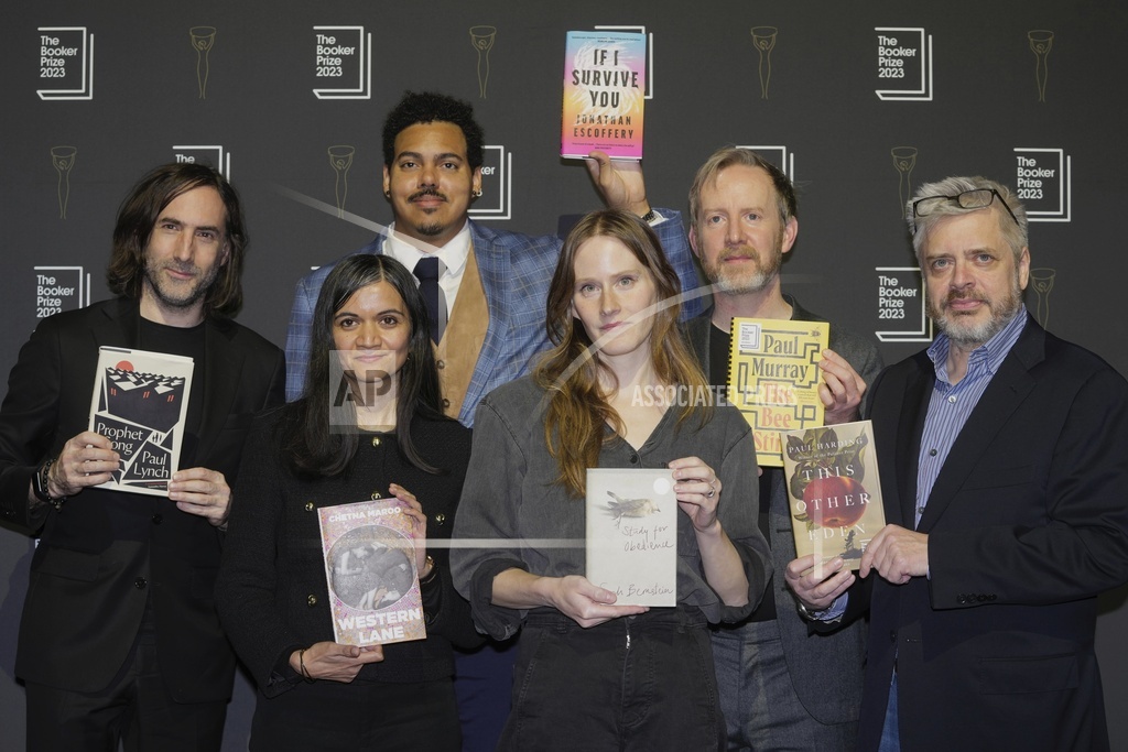 The authors pose with their books during a photocall for the Booker Prize 2023, in London