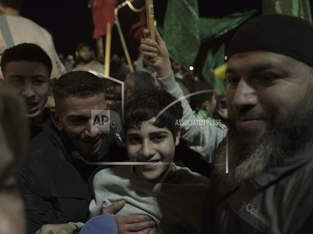 A Palestinian prisoner, center, released by Israel is welcomed to the West Bank