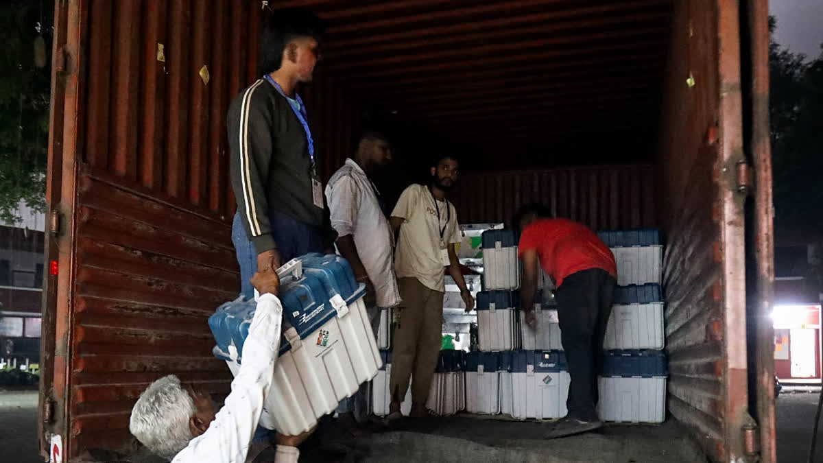 Electronic Voting Machines (EVM) being brought to a counting centre from a strong room ahead of the counting of the Maharashtra Assembly election,