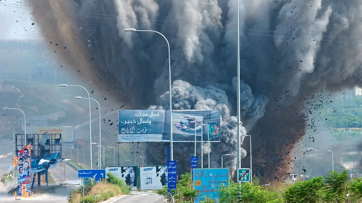 FILE - Smoke rises and debris flies from a bridge as it is targeted by an Israeli air raid, in the Zahrani region, on the Mediterranean coast, southern Lebanon, on July 14, 2006.