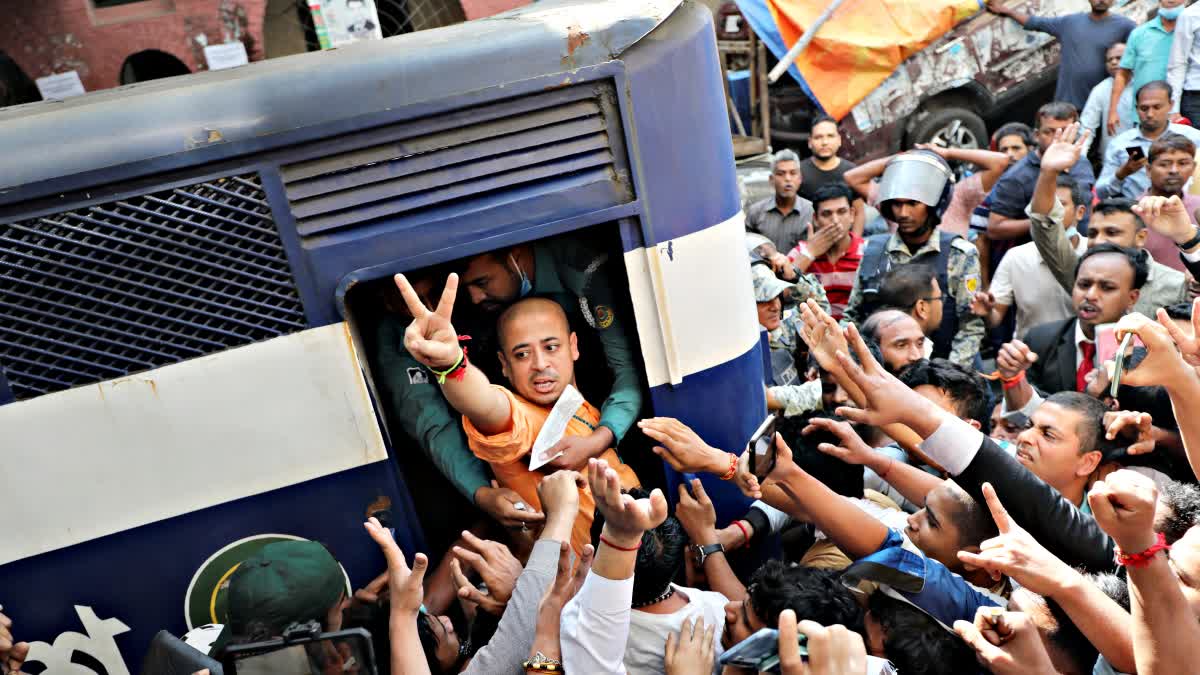 Bangladeshi Hindu leader Krishna Das Prabhu shows a victory sign as he is taken in a police van after court ordered him detained pending further proceedings in Chattogram in southeastern Bangladesh, Tuesday, Nov. 26, 2024