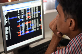 An Indian stock trader looks at share prices during intra-day trade at a brokerage house in Mumbai