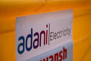 A logo of Adani Electricity Mumbai Limited (AEML) is pictured at a site along the street in Mumbai.