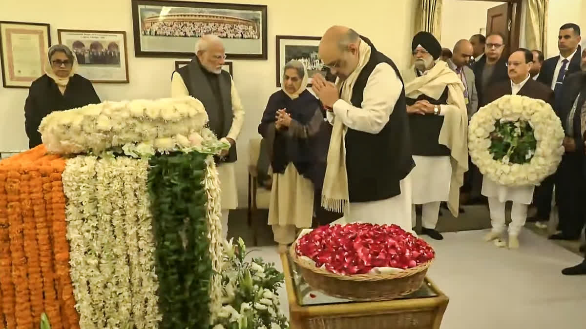 Union Home Minister Amit Shah pays his last respects to former prime minister Manmohan Singh at the latter's residence, in New Delhi, Friday, Dec. 27, 2024.