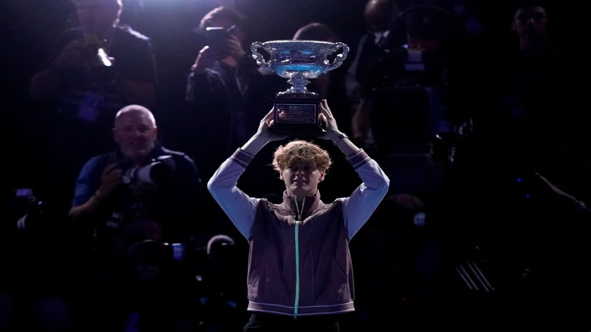 Jannik Sinner of Italy holds the Norman Brookes Challenge Cup aloft after defeating Daniil Medvedev of Russia in the men's singles final at the Australian Open tennis championships at Melbourne Park, in Melbourne, Australia, Sunday, Jan. 28, 2024. (AP Photo/Alessandra Tarantino)