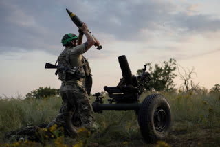 A Ukrainian serviceman of the 3rd Assault Brigade fires a 122mm mortar towards Russian positions at the front line, near Bakhmut, Donetsk region, Ukraine, Sunday, July 2, 2023. Employees from a Ukrainian arms firm conspired with defense ministry officials to embezzle almost $40 million earmarked to buy 100,000 mortar shells for the war with Russia, Ukraine's security service reported. The SBU said late Saturday, Jan. 27, 2024 that five people have been charged and the money has been recovered. (AP Photo/Alex Babenko, File)