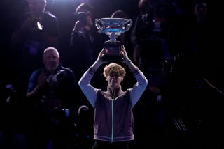 Jannik Sinner of Italy holds the Norman Brookes Challenge Cup aloft after defeating Daniil Medvedev of Russia in the men's singles final at the Australian Open tennis championships at Melbourne Park, in Melbourne, Australia, Sunday, Jan. 28, 2024. (AP Photo/Alessandra Tarantino)