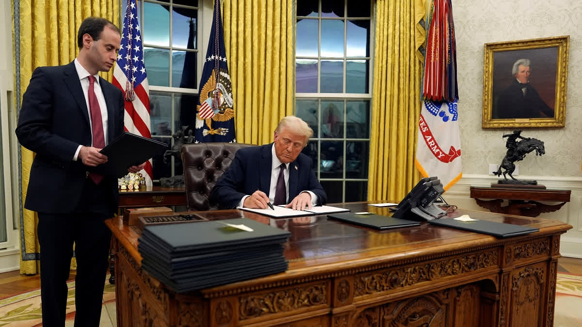 President Donald Trump signs an executive order withdrawing the U.S. from the World Health Organization in the Oval Office of the White House, Monday, Jan. 20, 2025, in Washington.