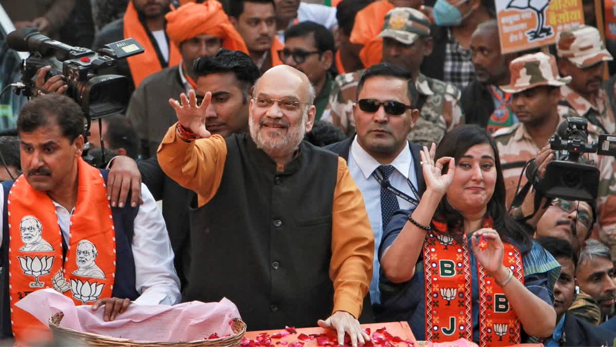 Union Home Minister and BJP leader Amit Shah with party MP Bansuri Swaraj during a roadshow in support of party candidate Neeraj Basoya ahead of Delhi Assembly elections, in New Delhi, Tuesday, Jan. 28, 2025.