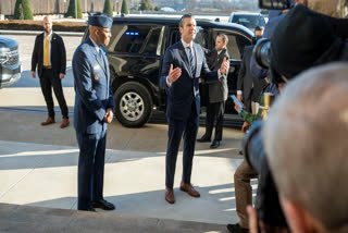 Defense Secretary Pete Hegseth, center right, talks to members of the press after arriving at the Pentagon, Monday, Jan. 27, 2025 in Washington. With Hegseth is Chairman of the Joint Chiefs of Staff Gen. Charles Q. Brown Jr., center left.