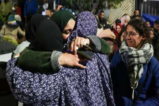 A Palestinian prisoner is welcomed by relatives upon the arrival of some 90 prisoners set free by Israel in the early hours of January 20, 2025 in the occupied West Bank town of Beitunia, on the outskirts of Ramallah.