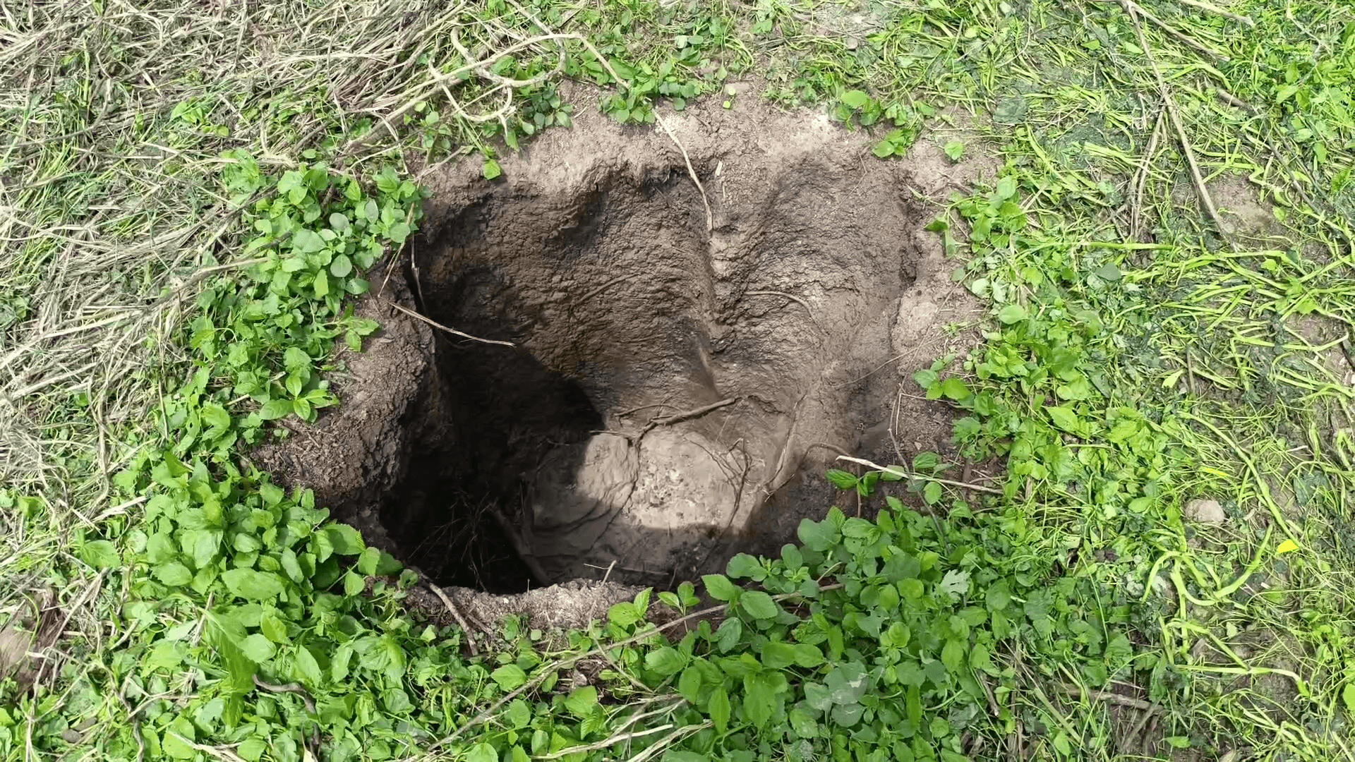 Five feet deep crater created by a falling meteorite (L) at Achamangalam village next to Jolarpet in Tamil Nadu's Tirupathur district