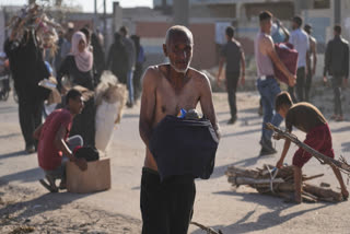 Palestinians carry boxes containing food and humanitarian aid packages delivered by the Gaza Humanitarian Foundation, a U.S.-backed organization approved by Israel, in Rafah, southern Gaza Strip, on Tuesday, May 27, 2025.