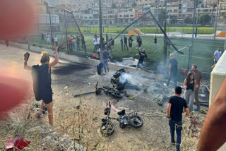 Residents rush to help injured children moments after a rocket attack hit a soccer field in the Druze town of Majdal Shams in the Israeli-controlled Golan Heights, Saturday, July 27, 2024