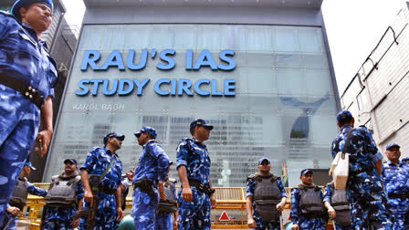 RAF personnel stand guard outside Rao's IAS Study Centre during a students' protest on Sunday