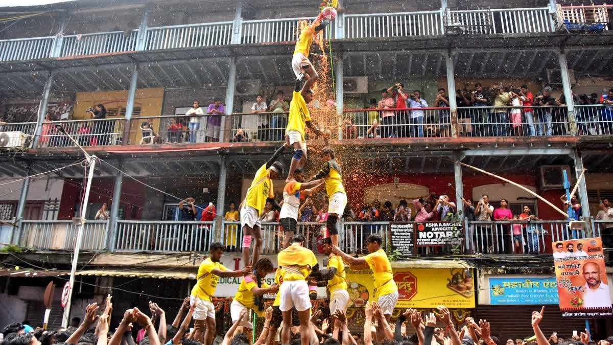 A group of boys make a human pyramid and break the Handi during the Dahi handi festival celebration at Dadar in Mumbai on Tuesday.