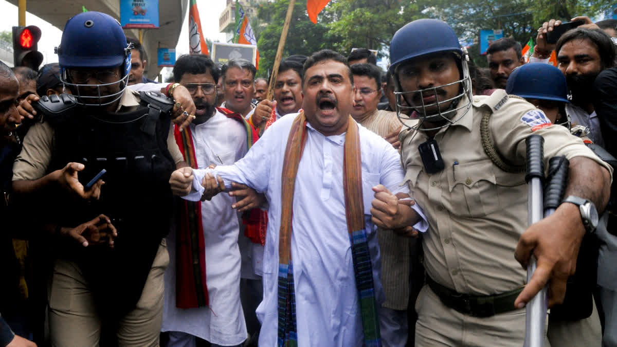 Police personnel detain Leader of Opposition in West Bengal Assembly Suvendhu Adhikari during a protest march to Swasthya Bhavan against the alleged sexual assault and murder of a postgraduate trainee doctor at Kolkata RG Kar Hospital, in Kolkata on Thursday.