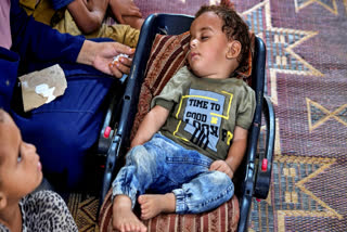 Displaced infant Abdel-Rahman Abu El-Jedian, who suffers from polio, sleeps at a makeshift tent camp in Deir al-Balah, central Gaza Strip, Tuesday, Aug. 27, 2024.