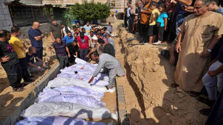 Palestinians bury the bodies of their relatives killed in the Israeli bombardment of the Gaza Strip, at a cemetery in Deir Al-Balah, Gaza, Monday, Oct. 23, 2023. Palestinians say the devastating war between Israel and Hamas is robbing them not only of their loved ones but also of the funeral rites that long have offered mourners some dignity and closure in the midst of grief. (AP Photo/Hatem Moussa, File)