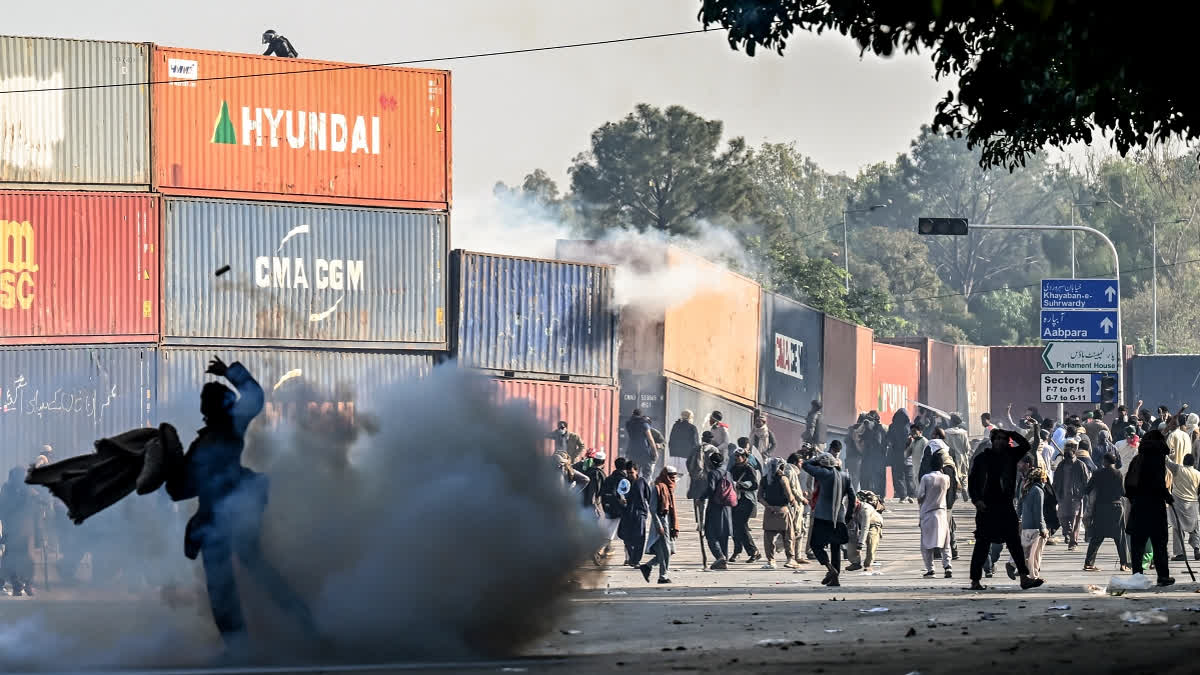 Policemen fire tear gas shells to disperse supporters of the Pakistan Tehreek-e-Insaf (PTI) party during a protest demanding the release of former prime minister Imran Khan, at the Red Zone area in Islamabad on November 26, 2024.