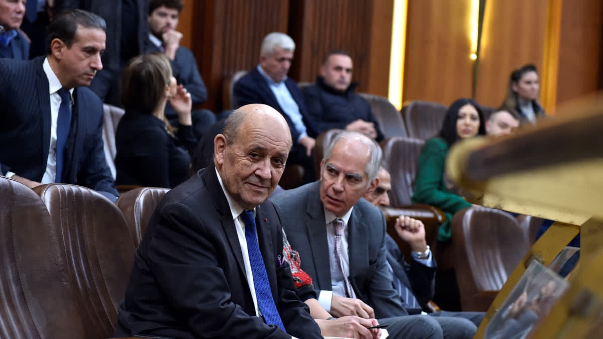 France's envoy to Lebanon Jean-Yves Le Drian (L) sits next to France's ambassador to Lebanon Hervé Magro, as he attends a parliament session at the Lebanese parliament in Beirut