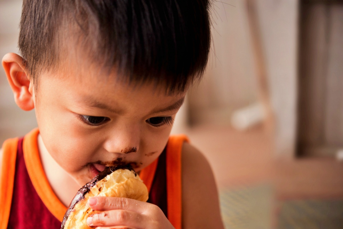 Boy eating a chocolate dessert