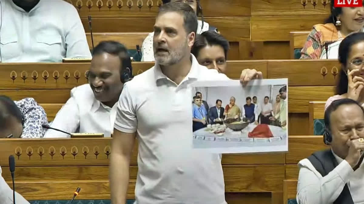 LoP Rahul Gandhi shows a poster of the traditional Halwa ceremony in Lok Sabha