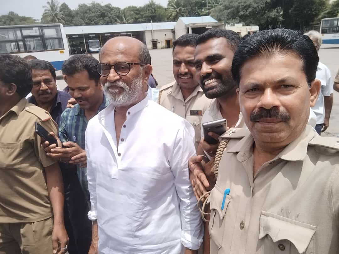 Superstar Rajinikanth recently made a nostalgic visit to bus depot no-4 of BMTC (Bengaluru Metropolitan Transport Corporation) in Bengaluru, Karnataka. Donning a white kurta and surrounded by police security, Rajinikanth graced the depot and warmly interacted with his devoted fans. The superstar also generously posed for photographs with the BMTC staff members.