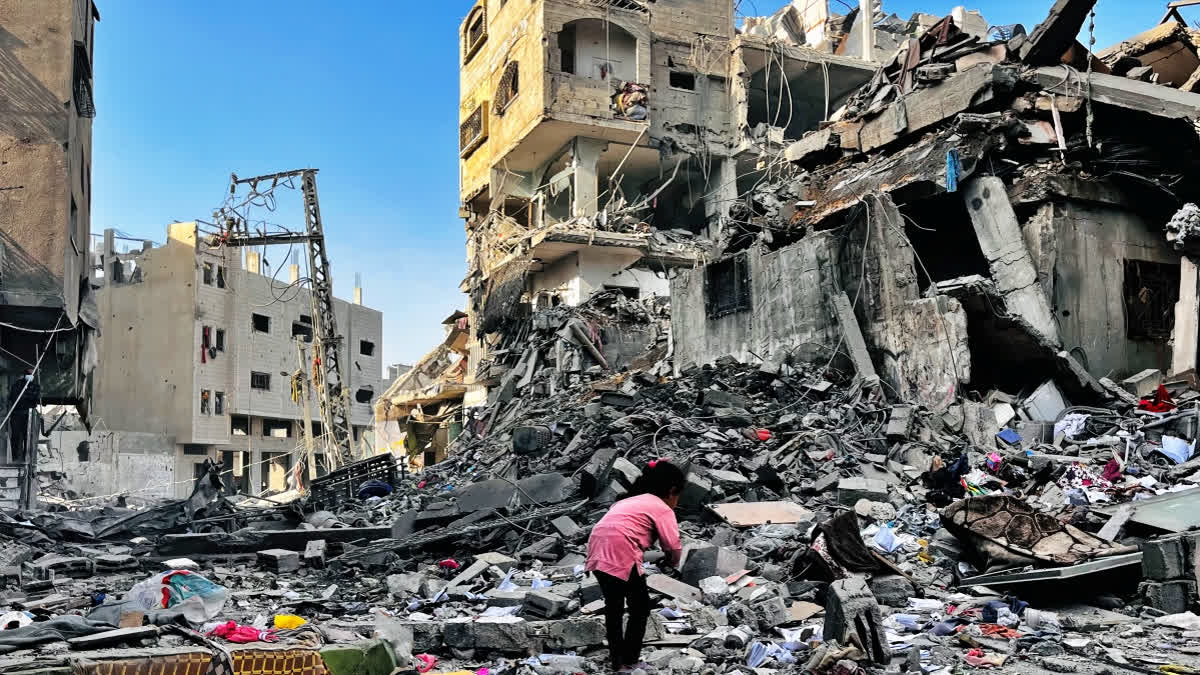 A Palestinian girl inspects the rubble of a building after an Israeli strike in Beit Lahia, in the northern Gaza Strip, on October 29, 2024, amid the ongoing war in the Palestinian territory between Israel and Hamas.