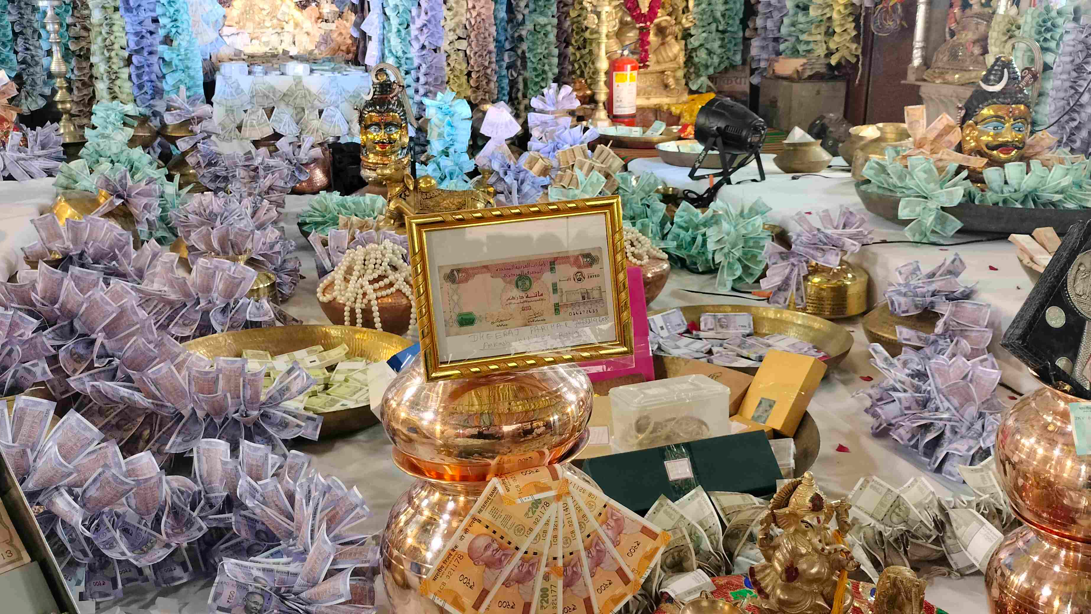 Gold and currency adorn the court of Ratlam Mahalakshmi Temple.