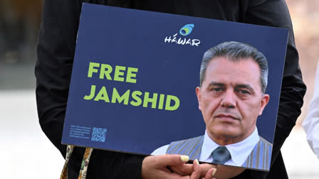 In this file photo taken on July 31, 2023 a demonstrator holds a picture of Iranian-German Jamshid Sharmahd in front of the German Foreign Ministry in Berlin.