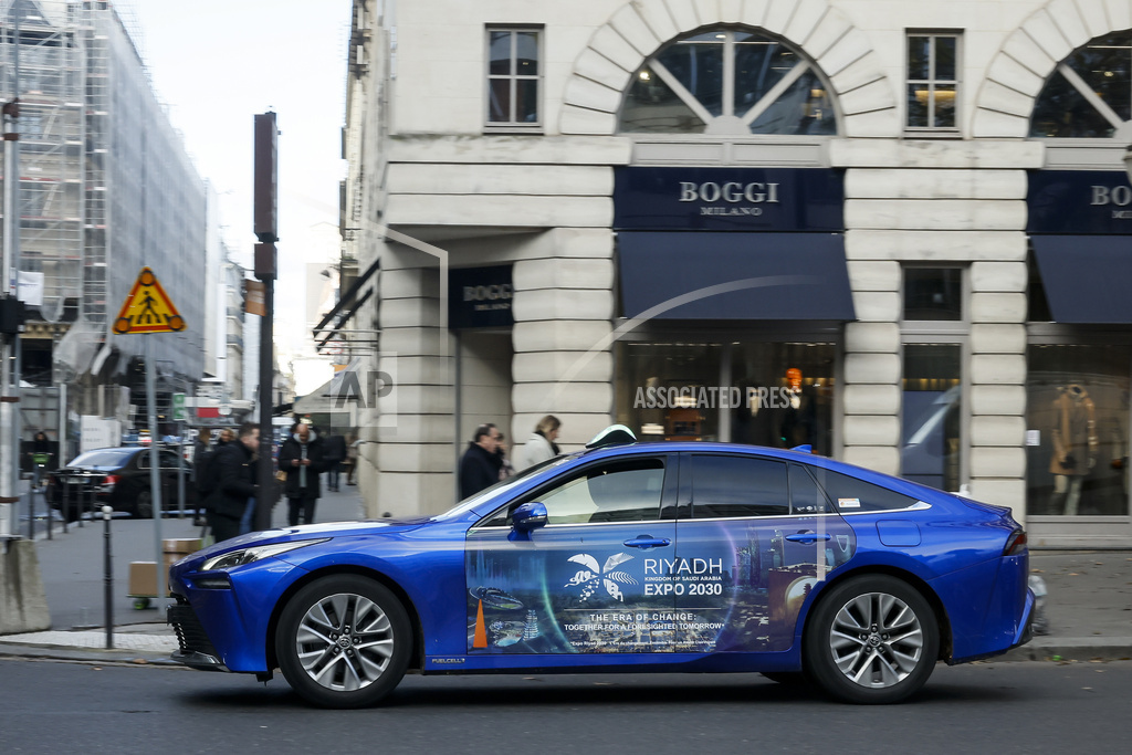 A taxi is decorated with a commercial for the Riyadh Expo 2030